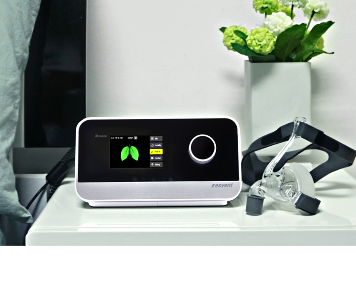 iBreeze machine with mask and flowers on a table