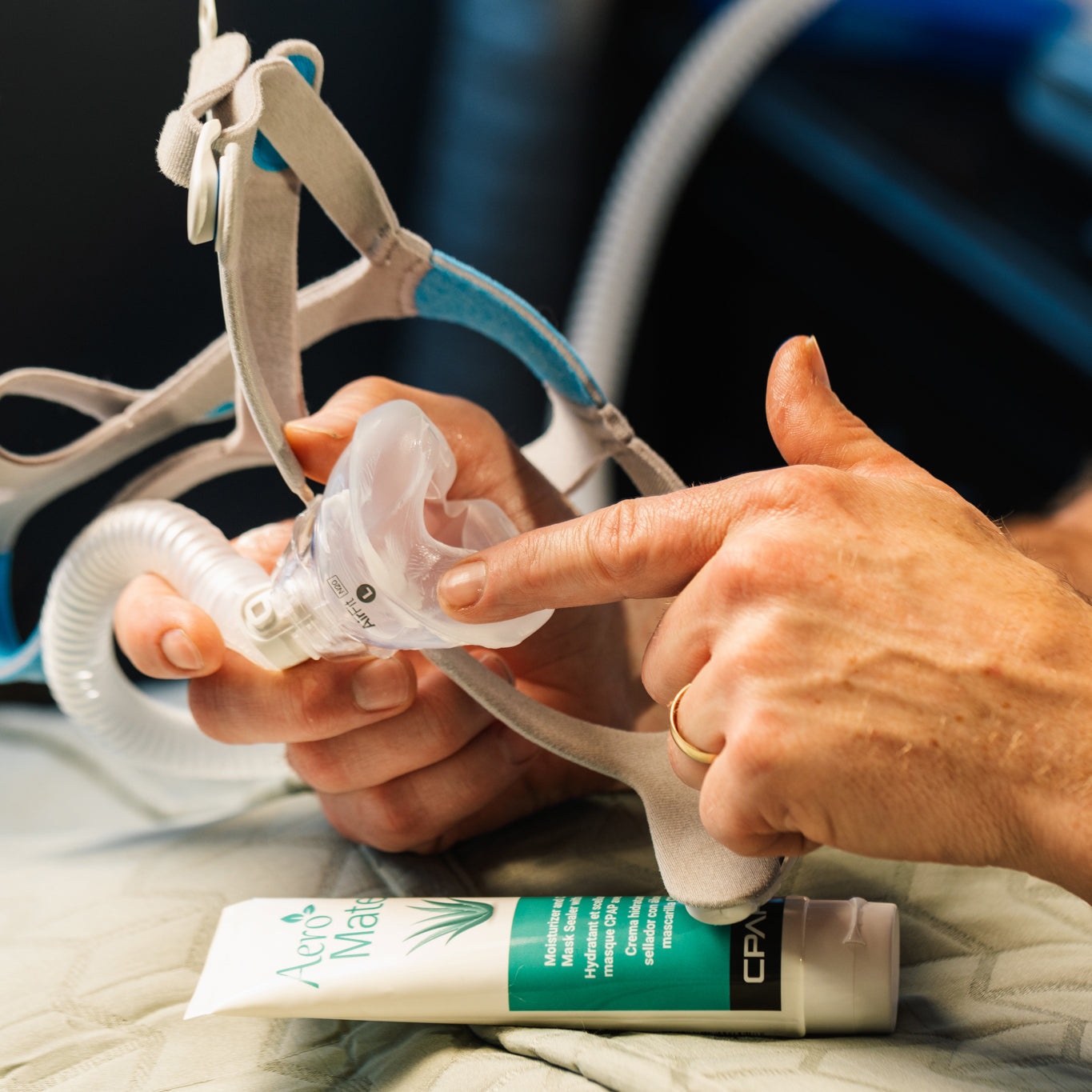 Person putting some CPAPology AeroMate CPAP Moisturizing Lotion on their CPAP cushion
