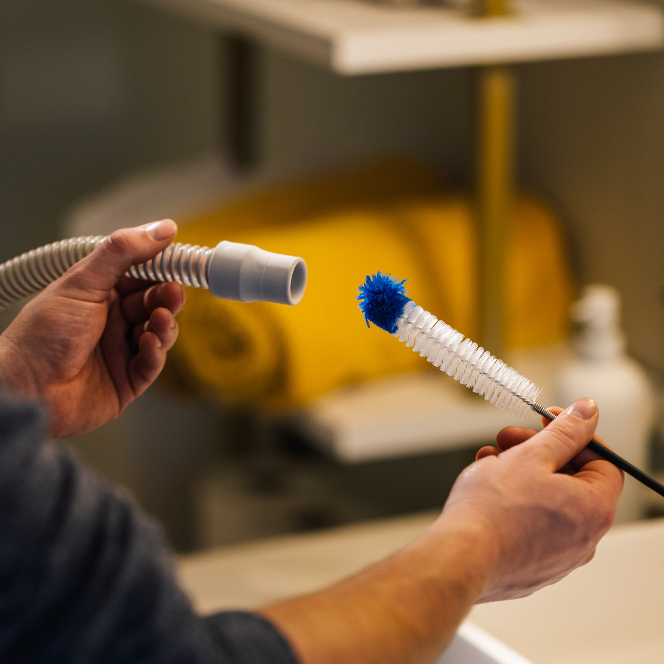 Person using the CPAPology Monty Elite Tube Brush