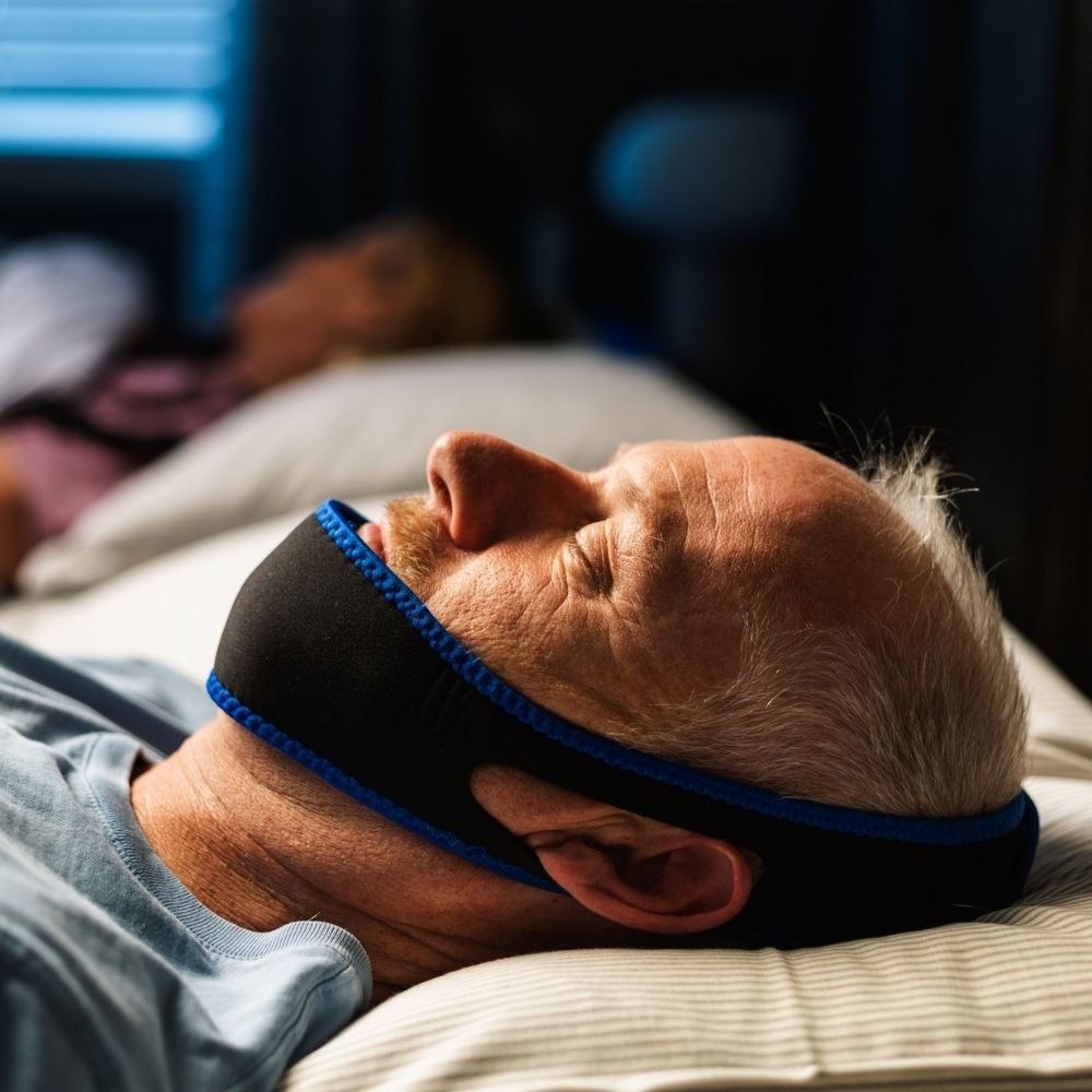 Man wearing the CPAPology Morpheus Classic Chin Strap to sleep