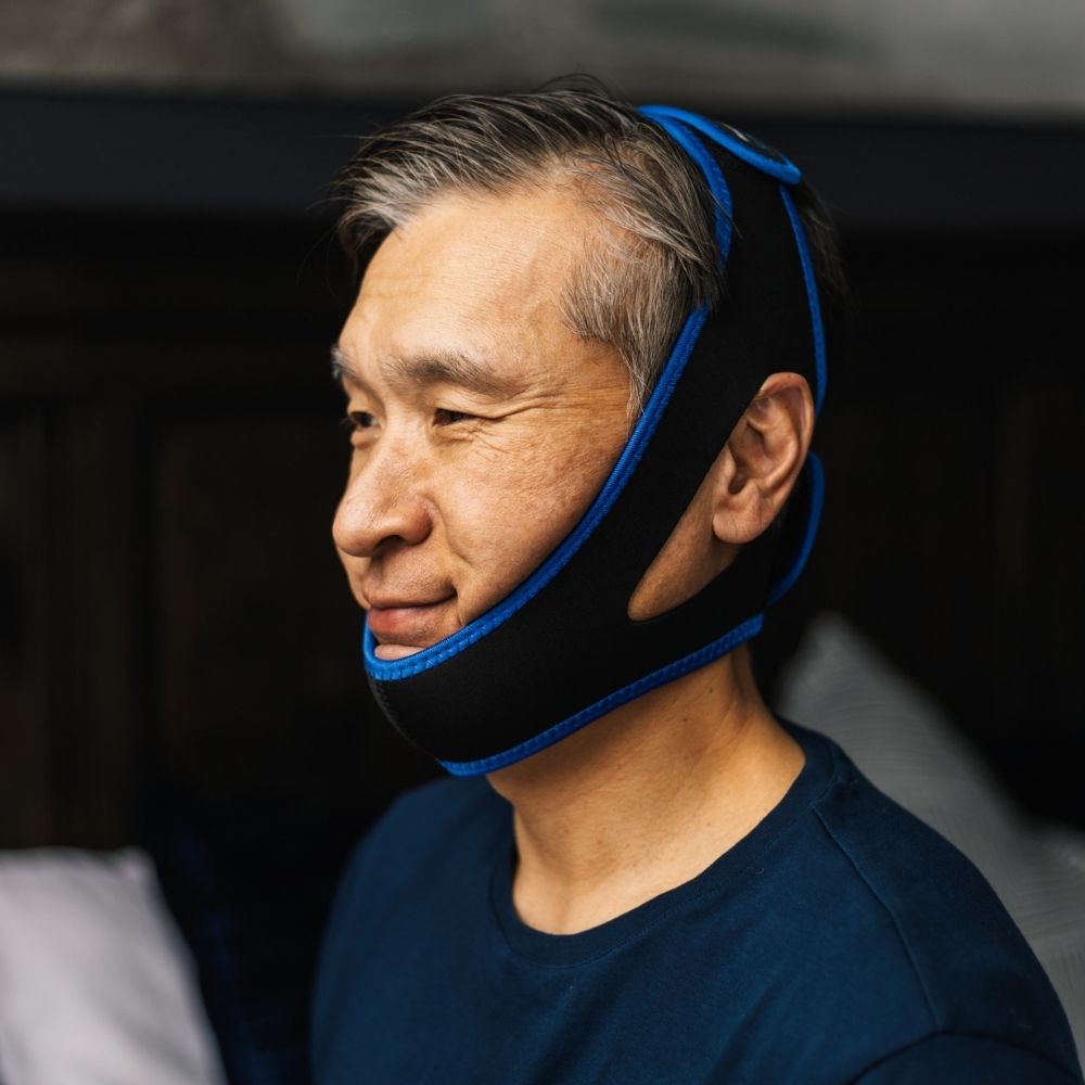 Side profile of person wearing the CPAPology Morpheus Deluxe Chin Strap