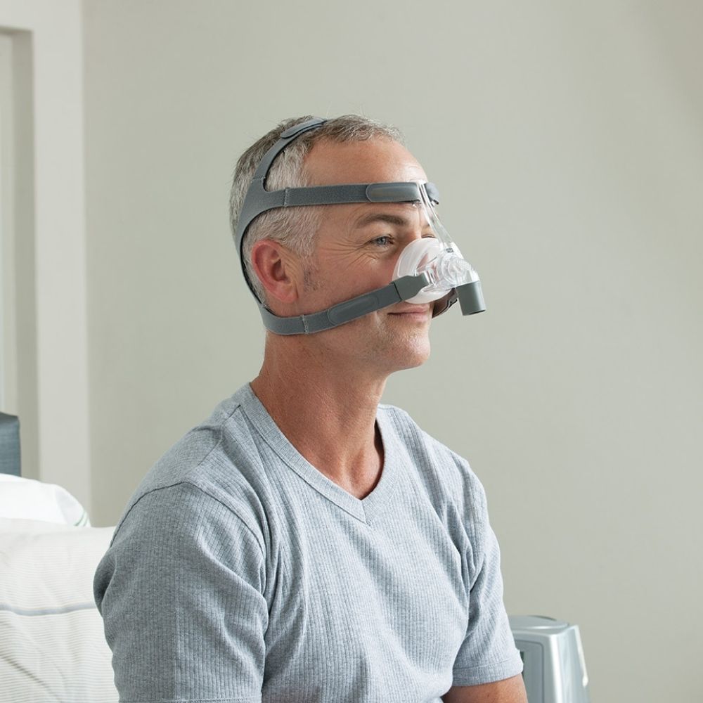 Side profile of man wearing the F&P Eson Nasal Mask