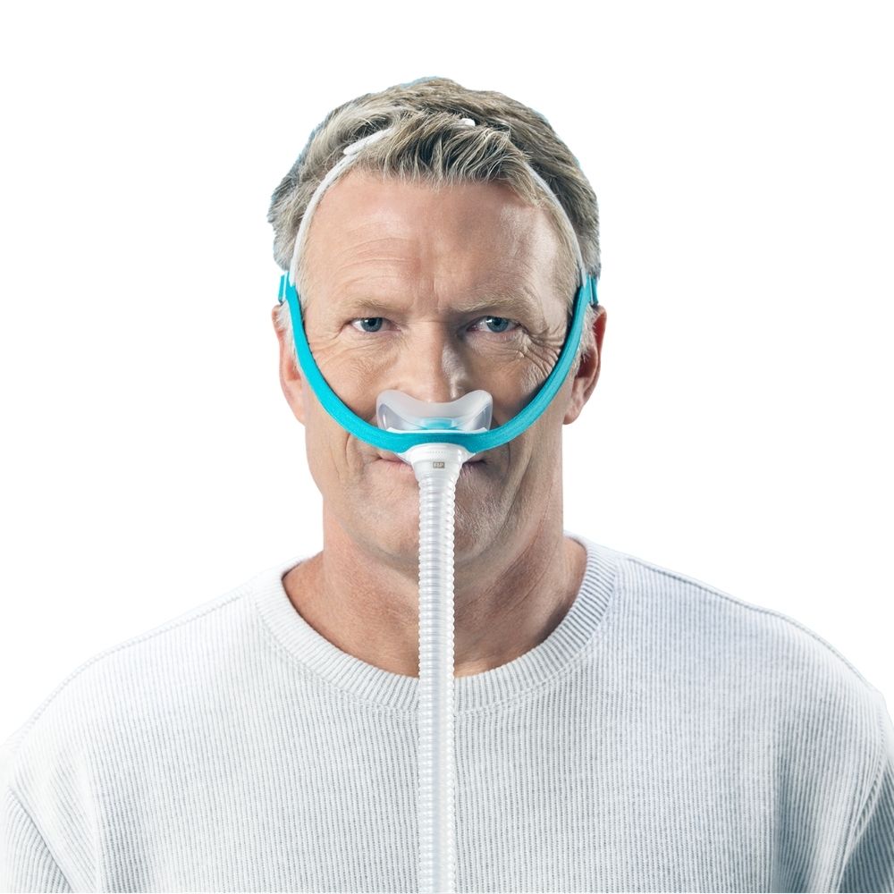 Front profile of a person wearing the F&P Evora Nasal Mask with a tube connected