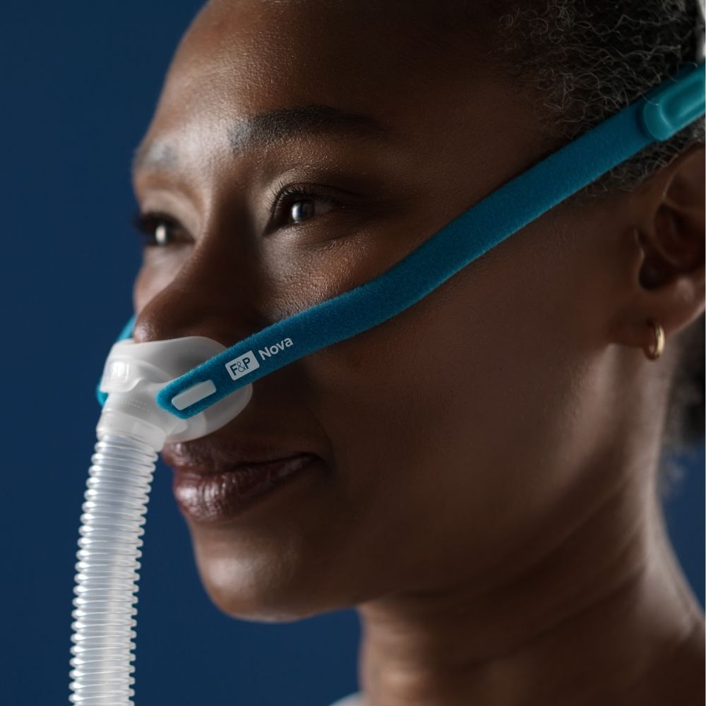 Side profile of a person wearing the F&P Nova Micro Nasal Pillow Mask