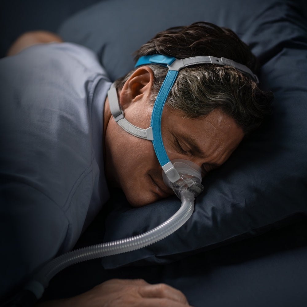 Person sleeping on their stomach while wearing the F&P Nova Nasal CPAP Mask