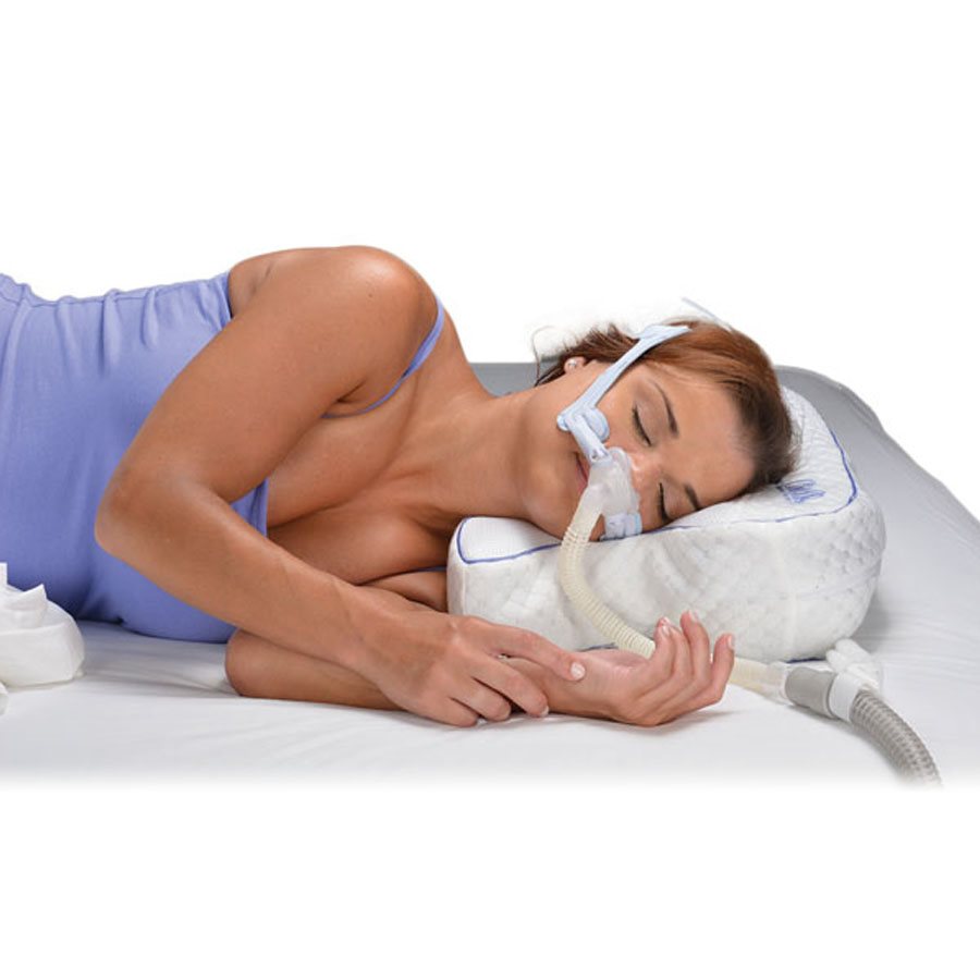 Person sleeping on Contour CPAP Max 2.0 Pillow while using a CPAP mask