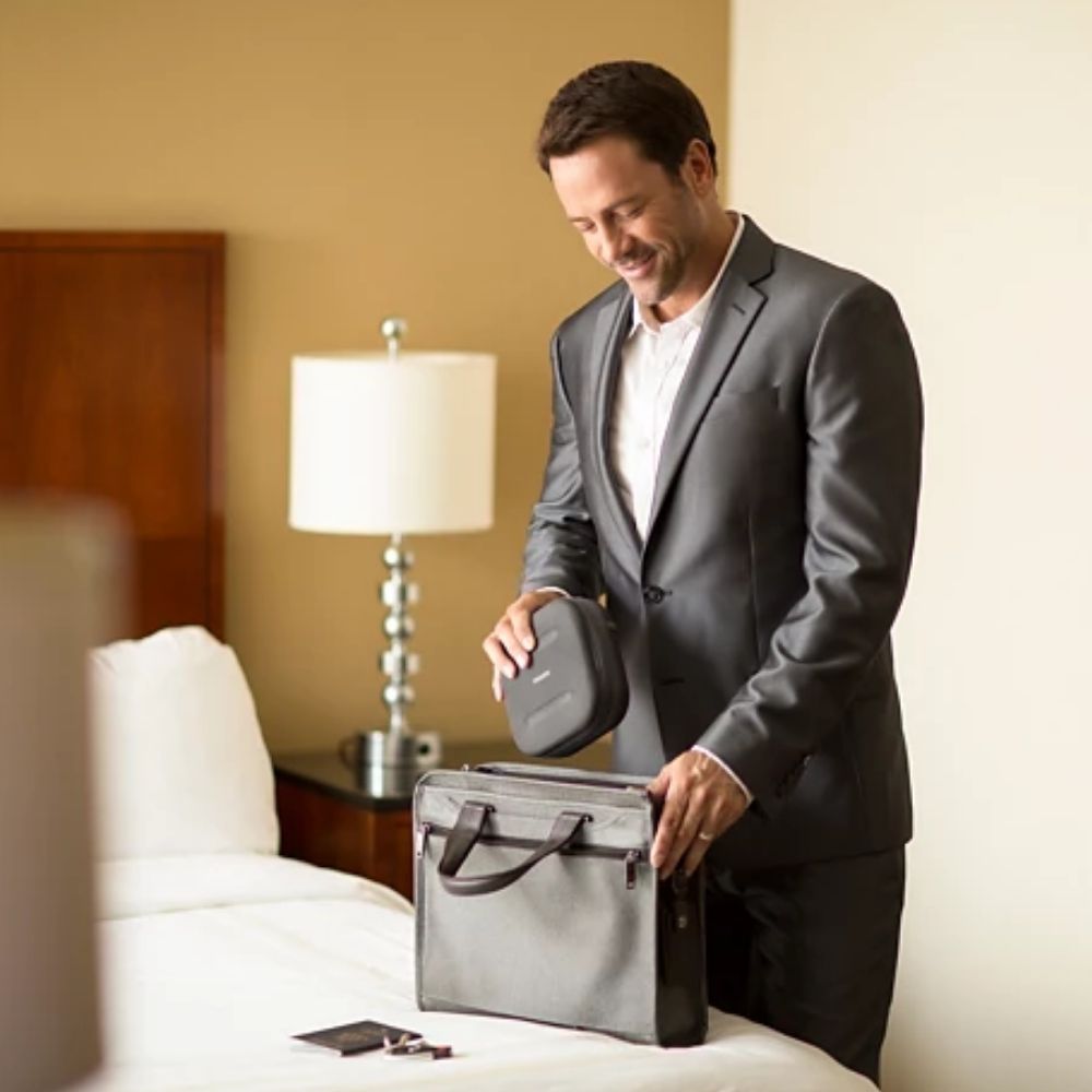 Small Philips DreamStation Go Travel Kit being placed inside a thin briefcase