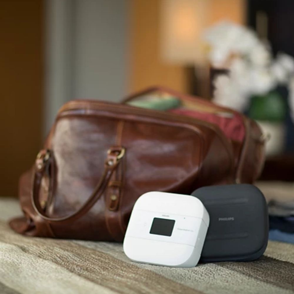 Small Philips DreamStation Go Travel Kit in front of a luggage tote