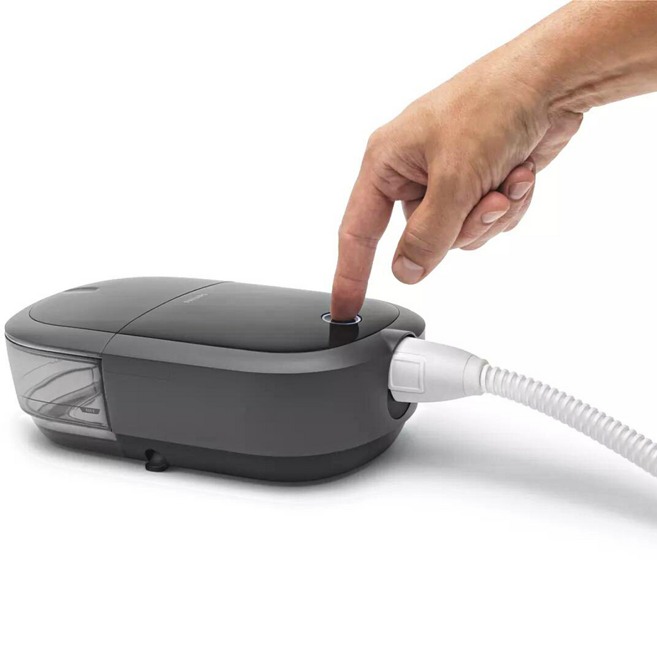 Hand pressing button on Philips DreamStation 2 CPAP machine
