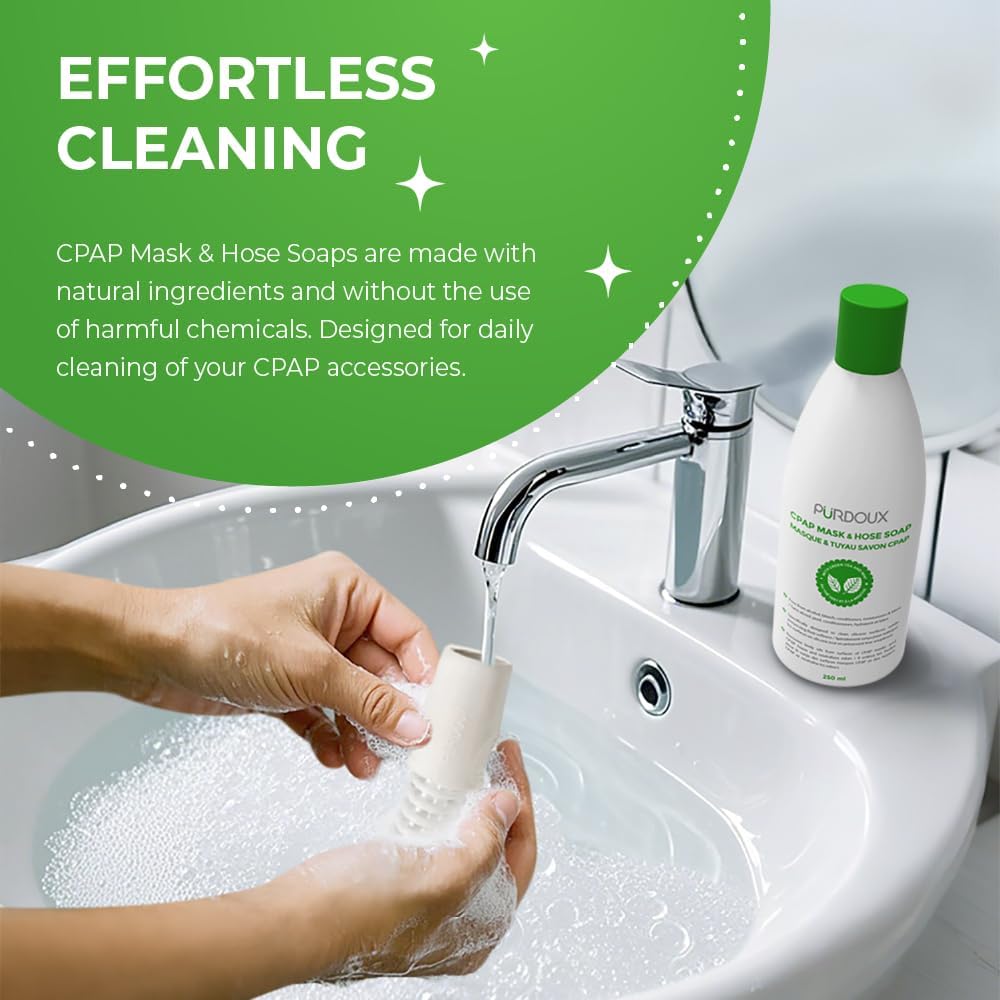 Person washing a CPAP mask with soap and water, with Purdoux CPAP Mask & Hose Soaps bottle on a sink