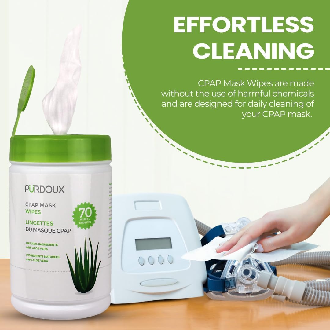 Purdoux CPAP mask wipes with a CPAP machine and a hand using wipes on a wooden surface