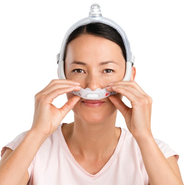 Person adjusting the cushion on the ResMed AirFit P30i nasal pillows CPAP mask
