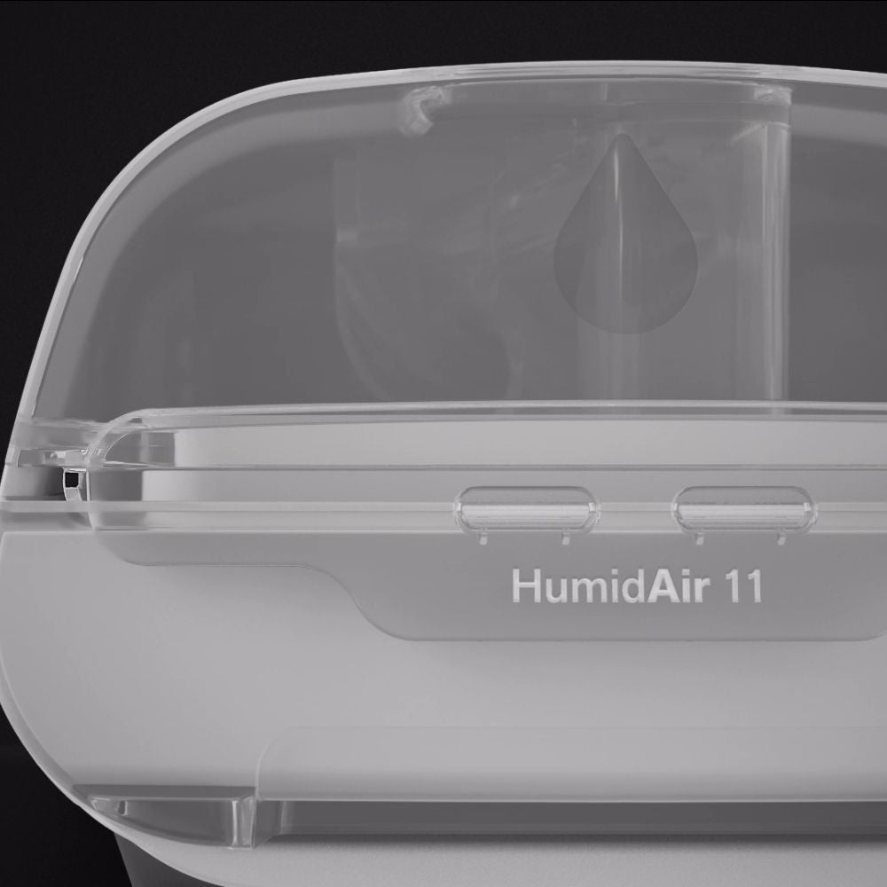 Humidifier labeled 'HumidAir 11' with a clear cover on a black background