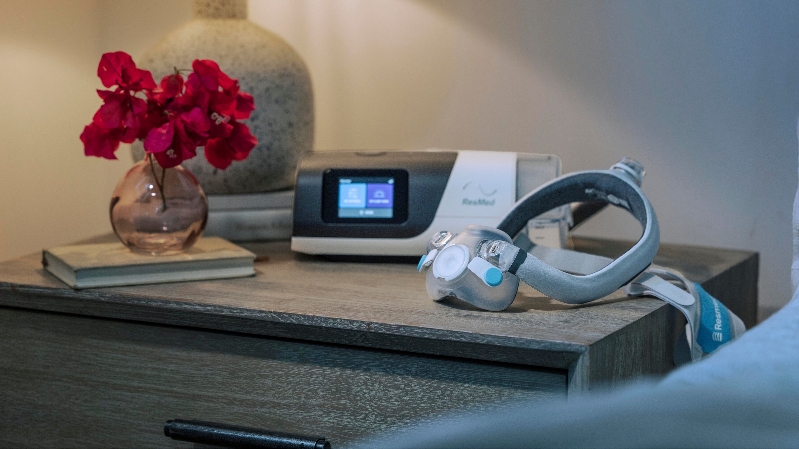 AirTouch F30i mask and AirSense 11 CPAP machine on a wooden nightstand