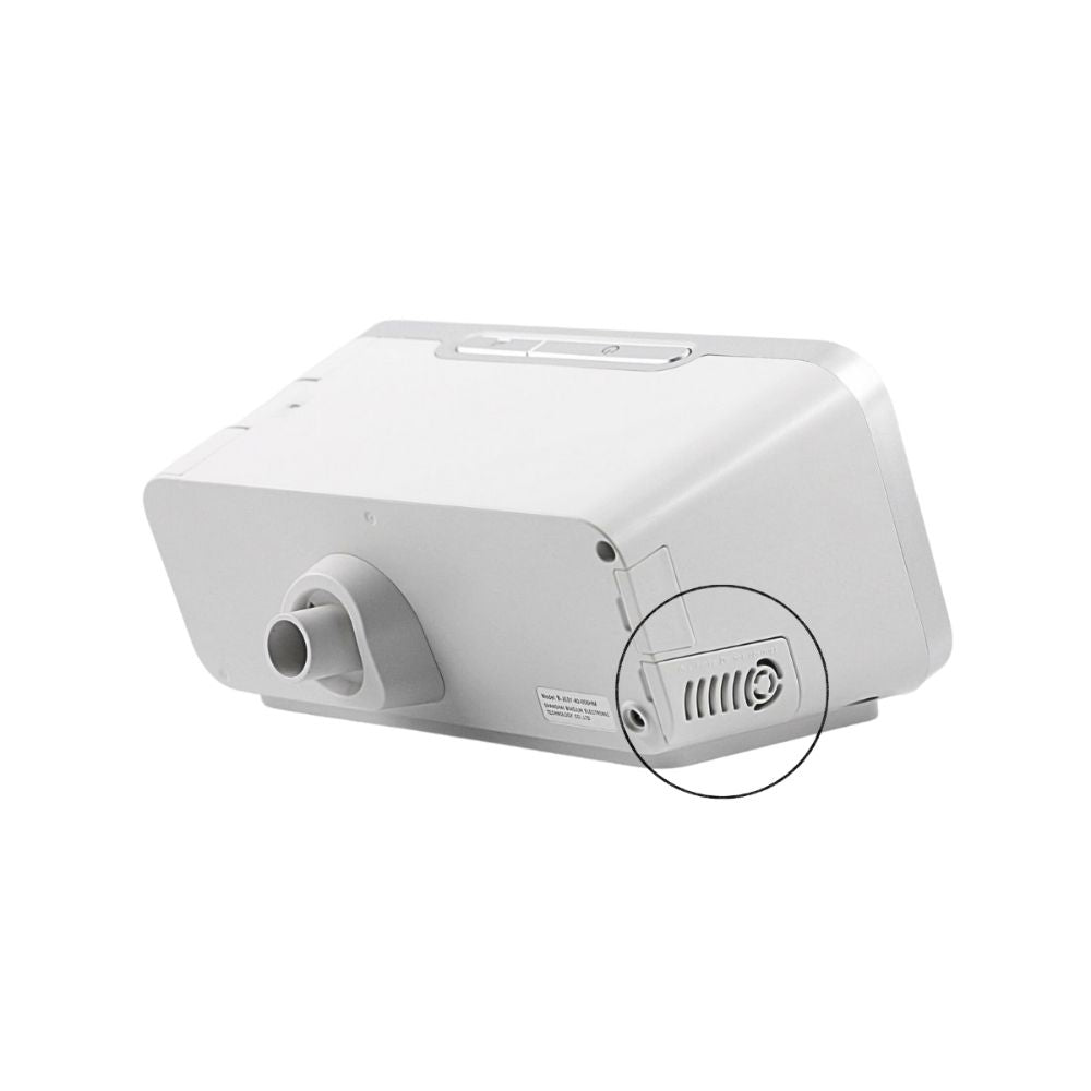 Side angled view of the back of the Resvent iBreeze with a black circle around where the air inlet filter cover is located