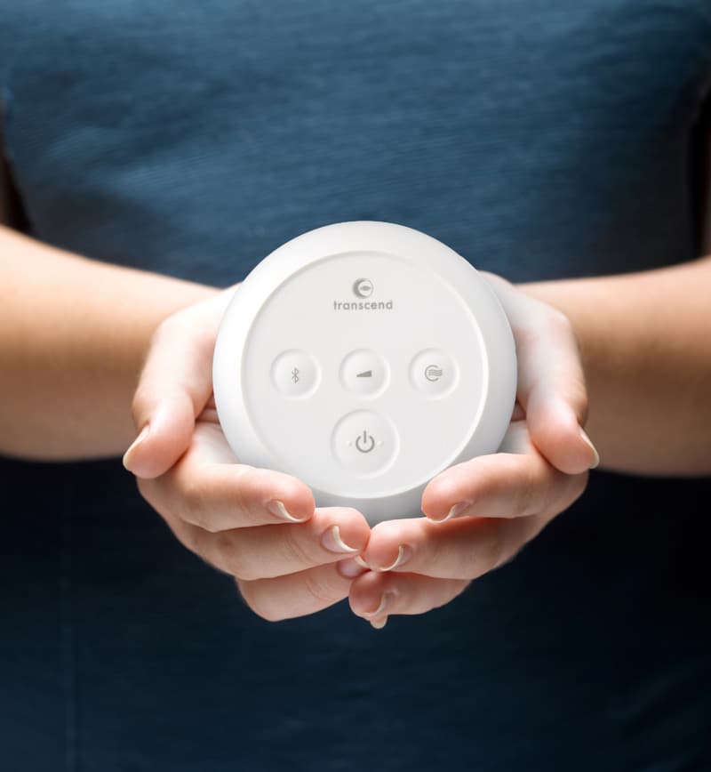 Person holding the Transcend Micro travel CPAP machine in the palms of their hands