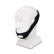 Black chin strap on a white mannequin head against a white background