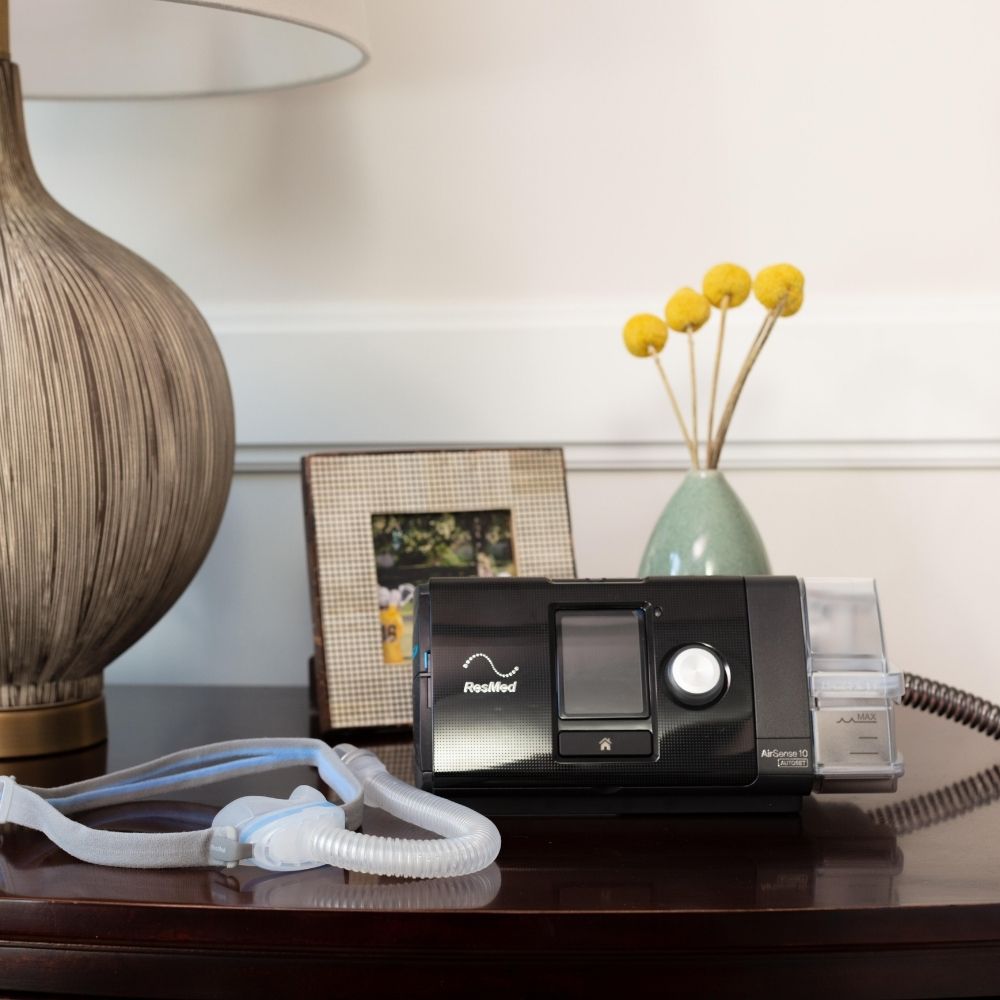 AirSense 10 CPAP machine and AirFit N30 nasal mask on wooden table